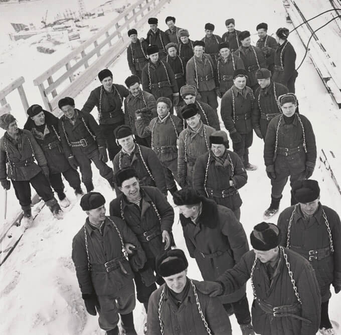 A black and white photo of a group of construction workers dressed for winter.