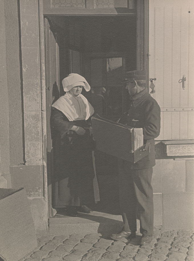 Postman delivers mail to a nun.