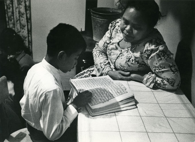 Boy reading the Koran with his mother, Holland, 1960