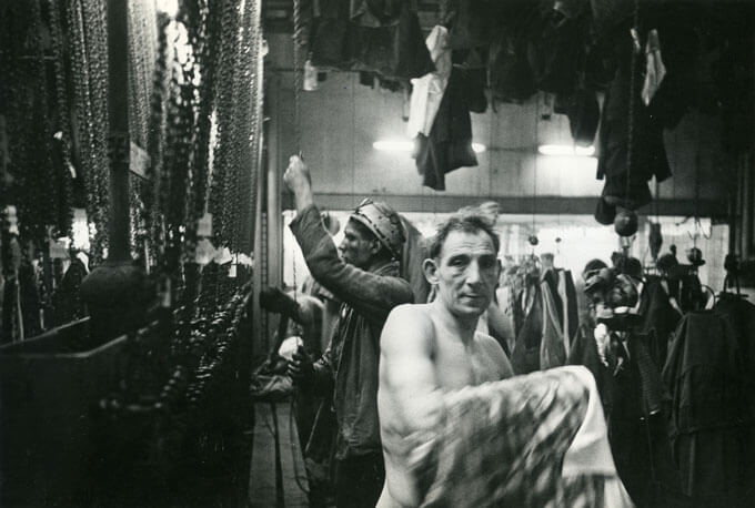Man changes clothes for work in a coal mine (Heerlen, Holland)