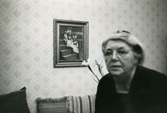 Woman at home with photo on wall in background, Bochum, W. Germany, 1965