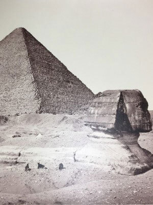 Silver print photograph of an Egyptian pyramid and a large Sphinx