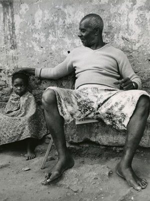 Grandfather rests his hand on his grandson's head.